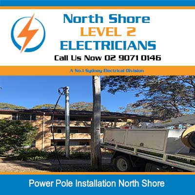 Utility truck with boom working on power pole in North Shore